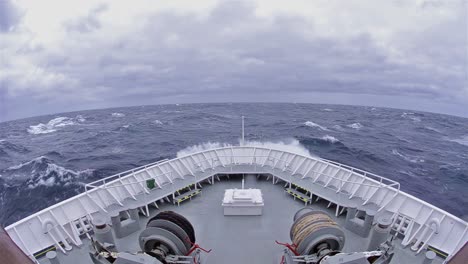 pov of ship's bow in a big wave and high winds on the drakes passage heading south the antarctic