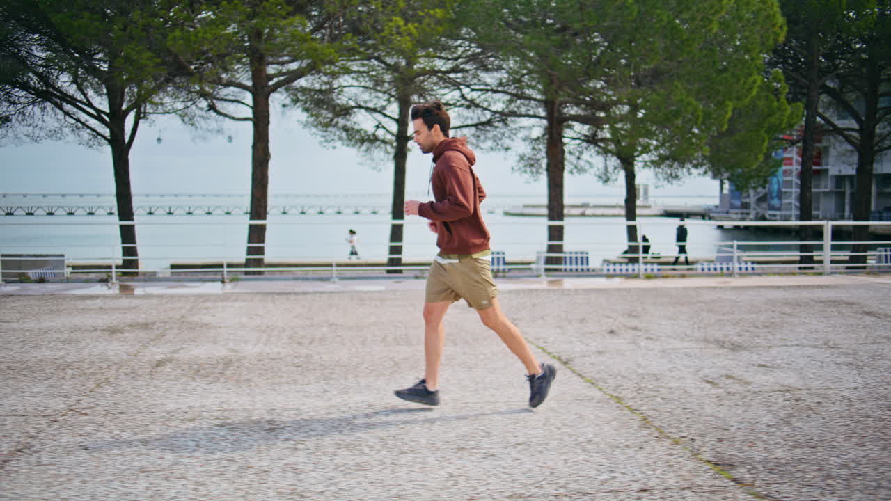 Active man running sent enjoying morning exercise. Motivated guy sprinting