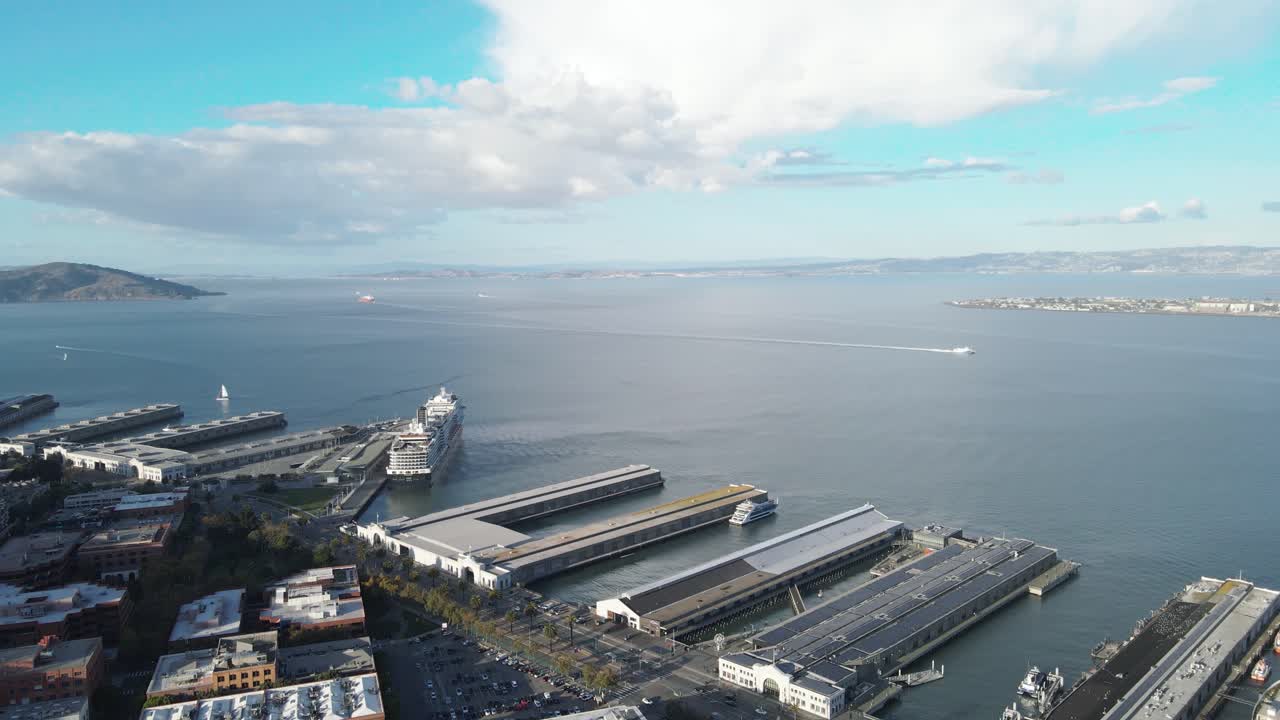 Aerial view of a coastal cityscape with piers, buildings