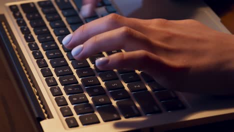 woman typing on laptop keyboard