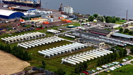 oil water tanks at the port fuel terminal in riga, latvia. aerial drone shot