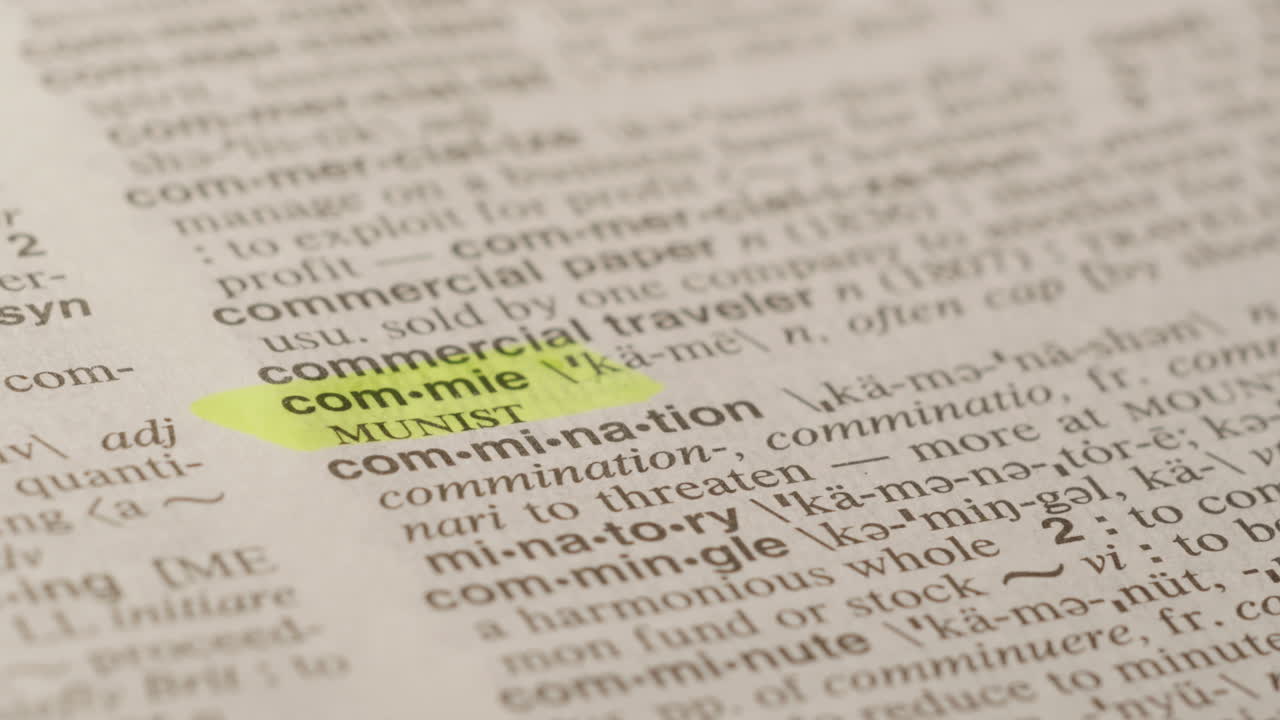 Commie, Political Dictionary Highlighter Concept, highlighting a word in a dictionary to show it's definition