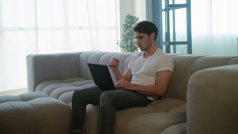 Upset-freelancer-man-working-laptop-computer-at-remote-workplace.