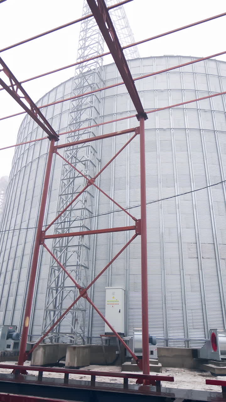 Large metal hangar for grain. Grain storage elevator, Large metal hangar for grain.. Vertical video