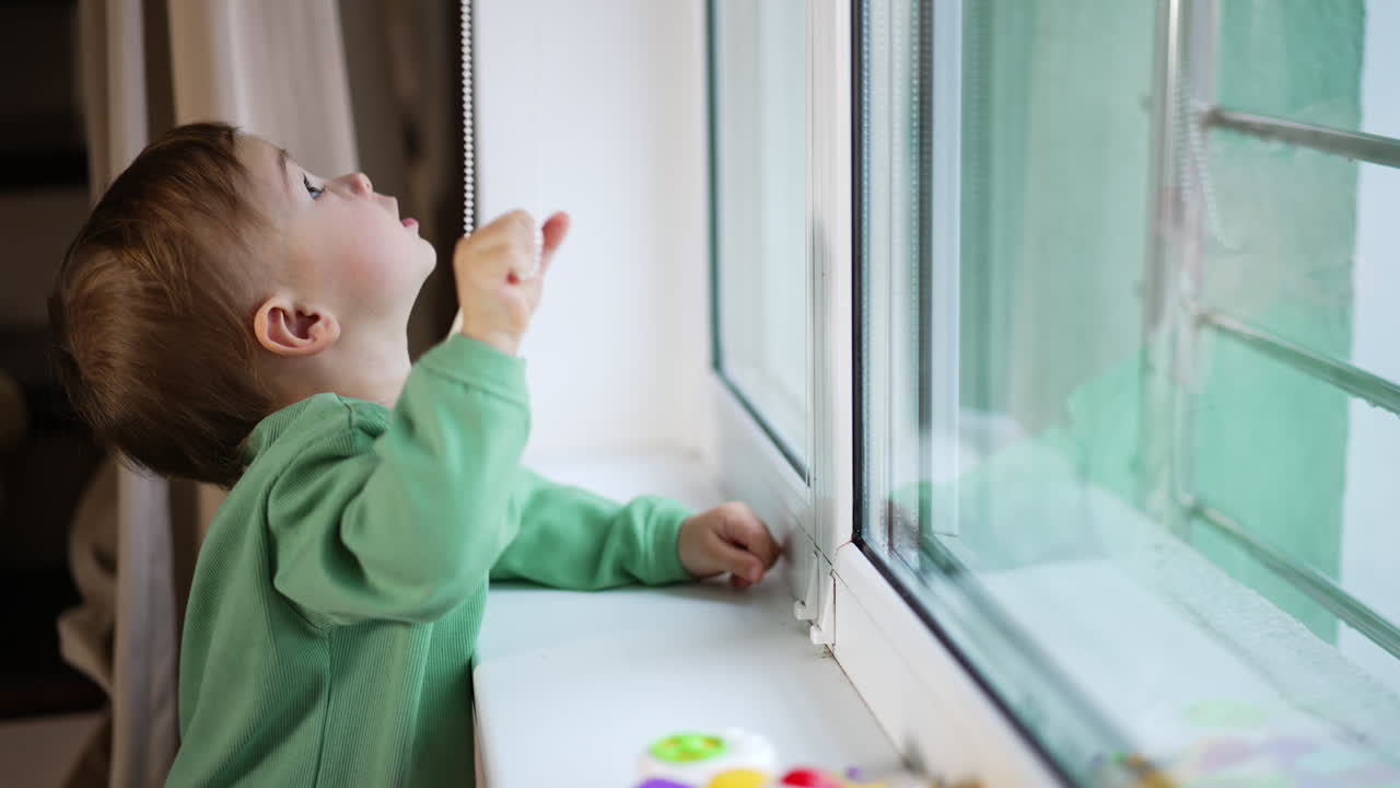 Toddler looking out the window