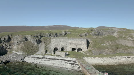 an aerial view of ard neakie abandoned lime kilns on a sunny summer's day