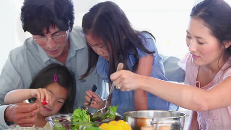 family making a salad together