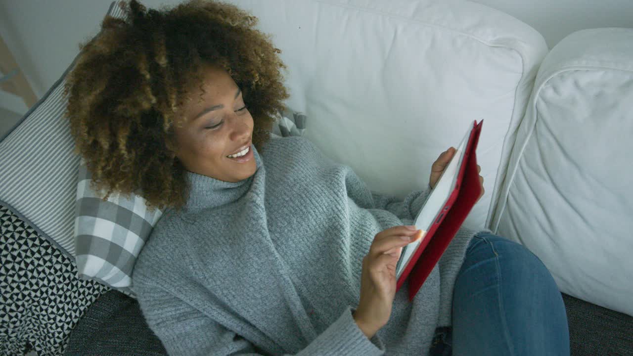 Woman chilling with tablet at home