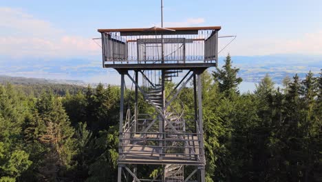 aerial drone shot close to pfannenstiel observation tower flying up and revealing lake zürich in the background