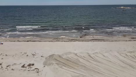 waves at sandy beach in cohasset - unidentified person on beach