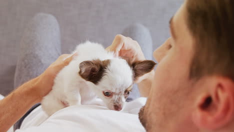 young man stroking his puppy at home 4k 4k