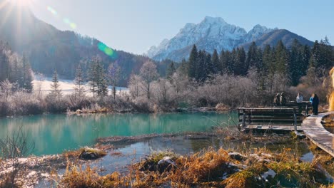 4K-video-of-a-young-caucasian-female-standing-near-the-lake-in-the-natural-reserve---Zelenci,-Slovenia