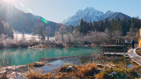 4k video of a young caucasian female standing near the lake in the natural reserve - zelenci, slovenia