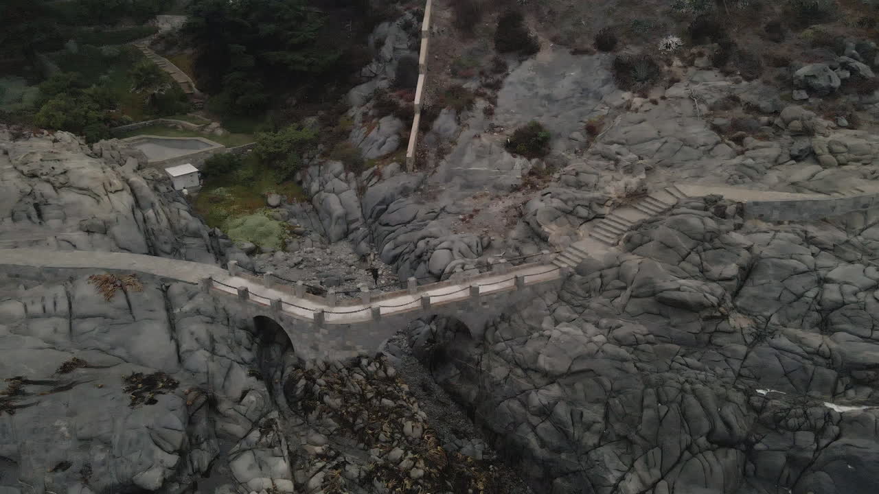 AERIAL - Stone bridge on coast of Zapallar, Valparaiso, Chile, wide circle shot