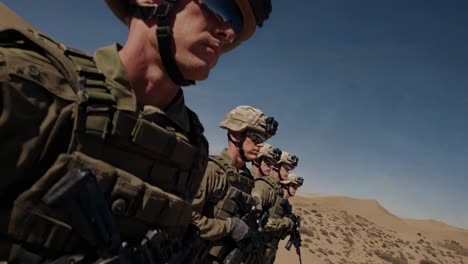 military personnel in desert terrain