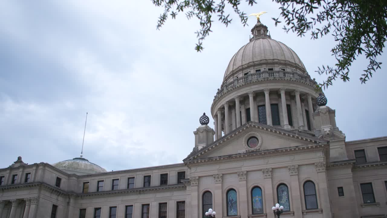 Medium rack away: Stormy skies over the Mississippi State Capitol building. Jackson, MS