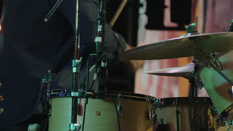 Drummer-plays-drum-set-on-stage-during-public-concert-performance