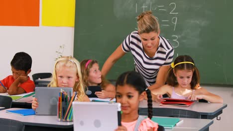 teacher teaching kids on digital tablet