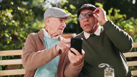 Elderly Men Using a Smartphone Outdoors