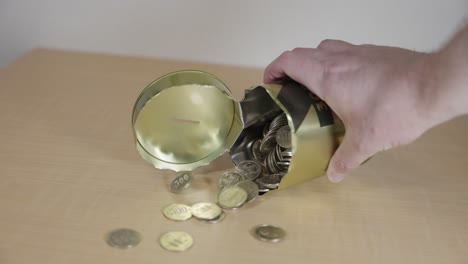 Piggy-Bank-Broken-Open-and-Hundreds-of-Coins-Pouring-onto-Table