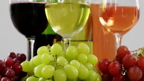 Various-grapes-and-wines-on-wooden-plank