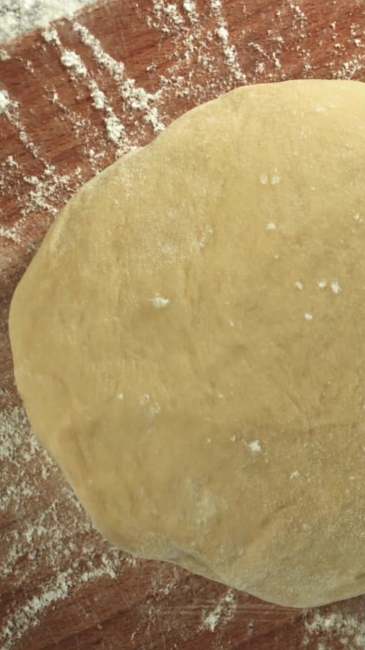 Fresh Dough Resting on a Floured Wooden Surface