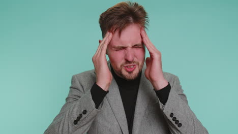 business man rubbing temples to cure headache problem suffering from tension and migaine stress pain