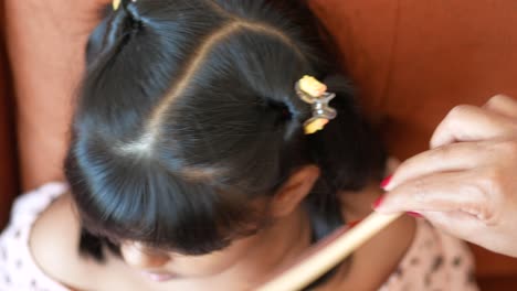 child's hair being styled