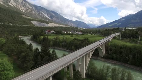 a drone shot of a bridge above a river