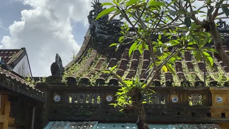 mossy pagoda roof of guan di buddhist temple in unesco world heritage site in hoi an, vietnam