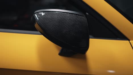 folding side mirror on yellow sports car