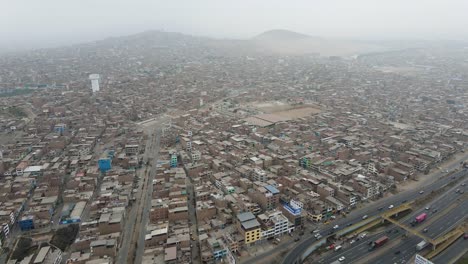 aerial shot of houses next to a highway in the crowded neighborhood of ventanilla