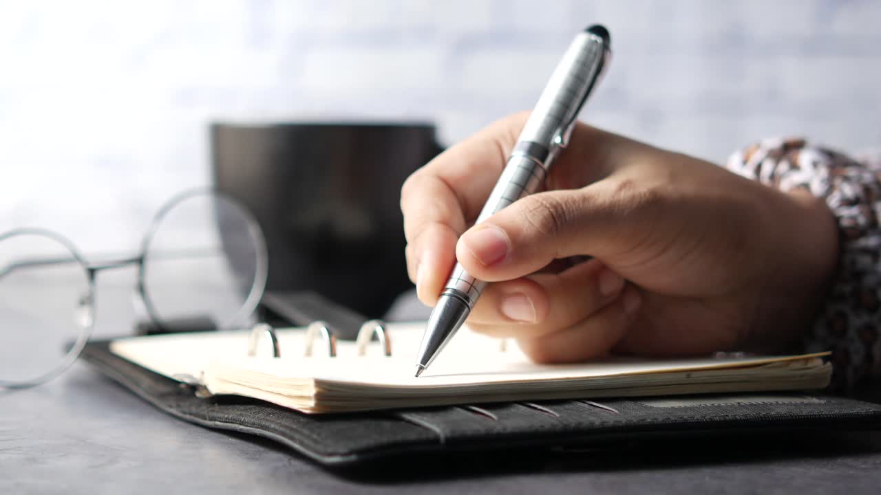 Person writing in a notebook