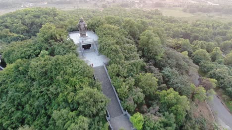 Drohnen-Luftaufnahme-In-Vietnam,-Die-Bei-Sonnenuntergang-über-Buddhistische-Tempelanlagen-Mit-Pagoden-Und-Mit-Grünen-Bäumen-Bedeckten-Straßen-In-Ninh-Binh-Fliegt