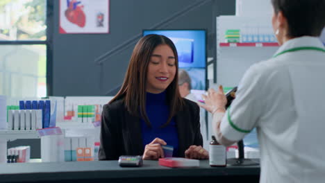 Woman-in-chemist-shop-at-checkout