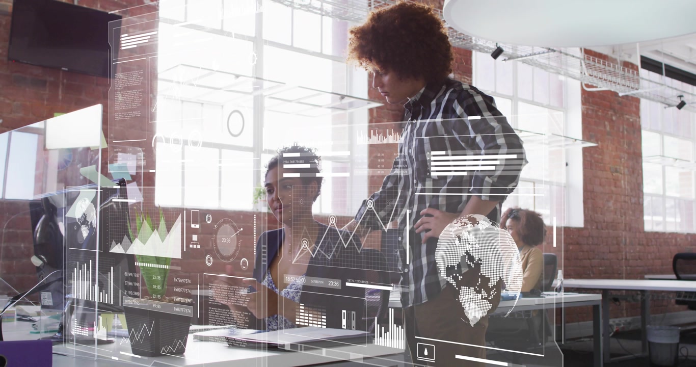 Manager leaning and pointing at tech graph while data analyst zooming into overlay for insights
