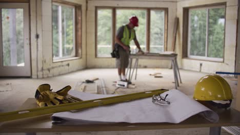 focus on items in foreground with construction worker in background