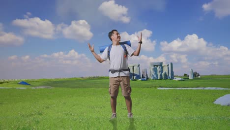 happy tourist with backpack in a field