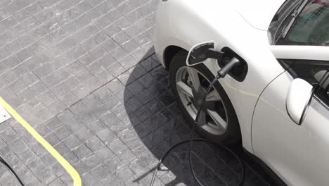 Progressive-innovation-urban-electric-on-street-charging-station-with-EV-car.