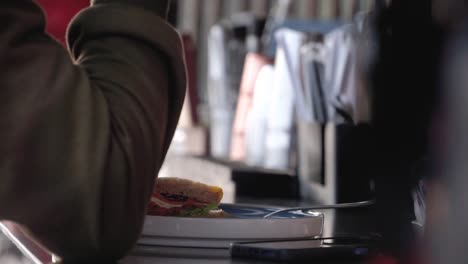 Close-up-shot-hand-of-people-hold-the-sandwich-and-eating-it