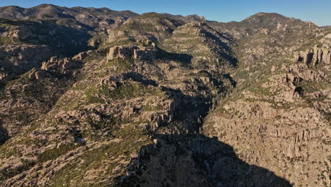 Mt-Lemmon-Arizona-Aerial-v6-cinematic-panning-view,-flyover-Windy-Point-Vista-capturing-rough-texture-of-craggy-rock-terrain-and-spectacular-mountain-landscape---Shot-with-Mavic-3-Cine---March-2022