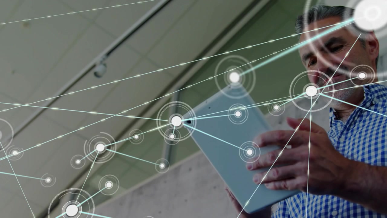 Opening network app revealing nodes spanning atrium while man swiping tablet for data monitoring