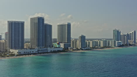 hallandale beach florida aerial v1 cinematic pan shot capturing beachfront residential condo, luxury hotel resort and high rise buildings at hollywood city - march 2021