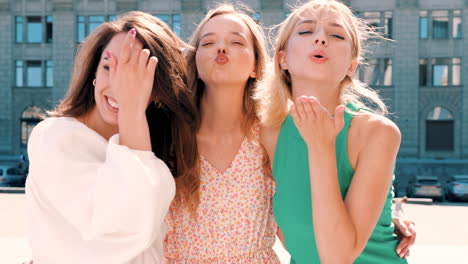 three happy women friends in city