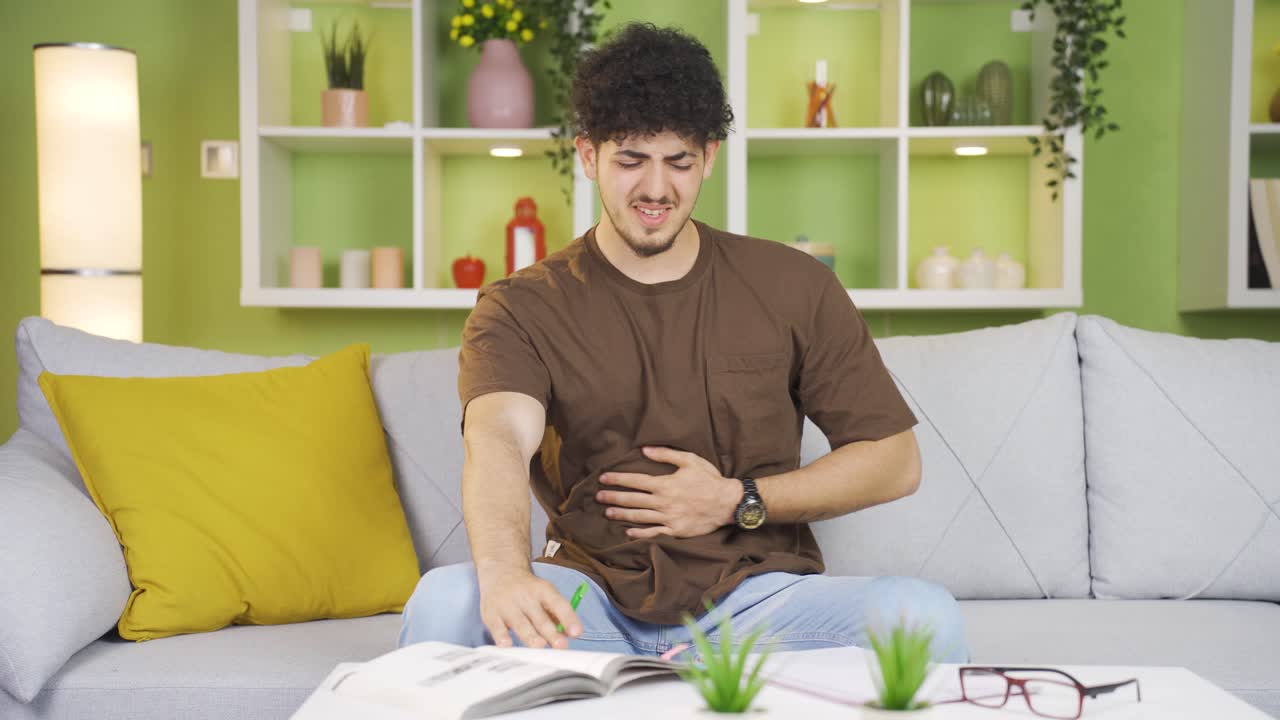 Young man suffering from stomachache.