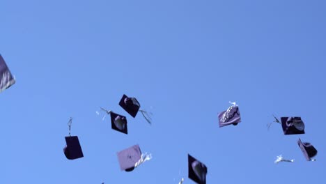 graduation day hat toss with sky background