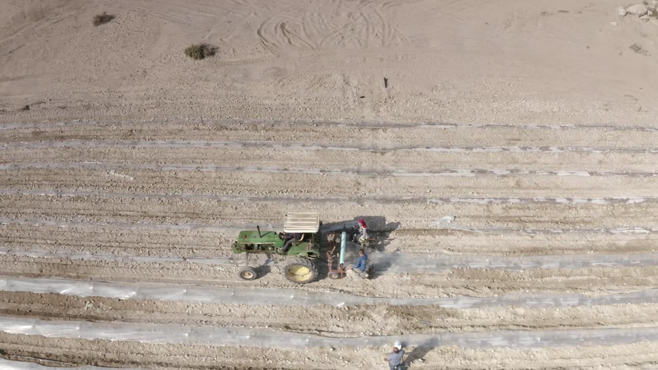 Aerial View of Farmland with Tractor and Workers