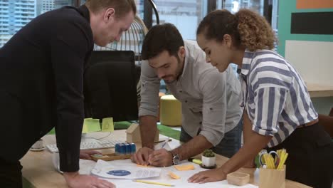 Creative-business-people-group-having-conversation-at-office-desk-in-workplace.