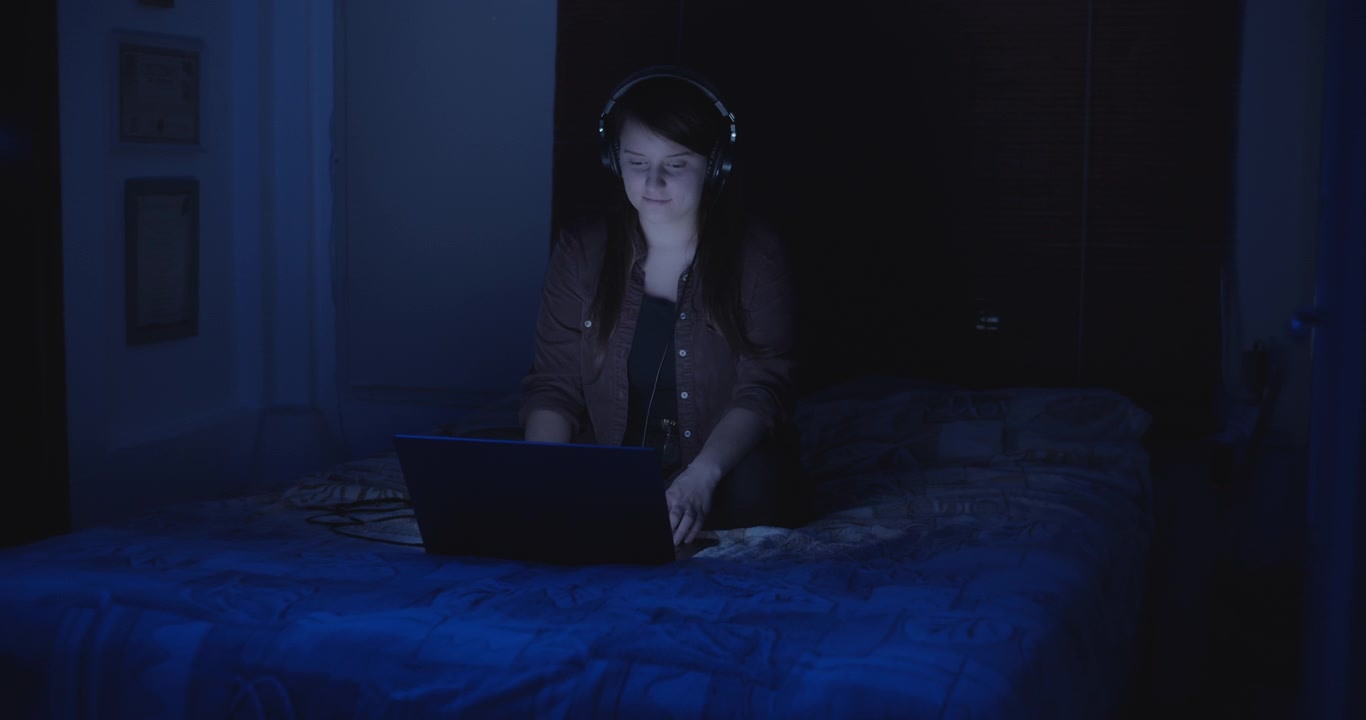 Girl watches music videos in headphones