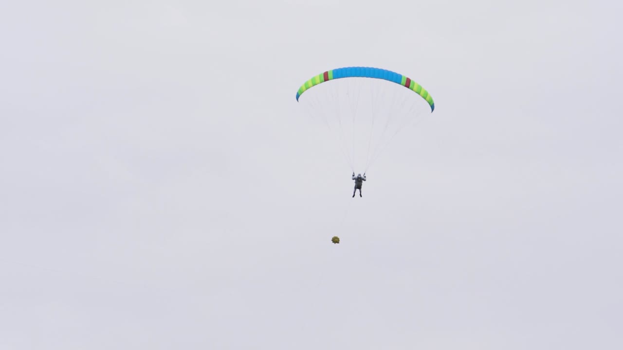 Person Paragliding in Cloudy Sky